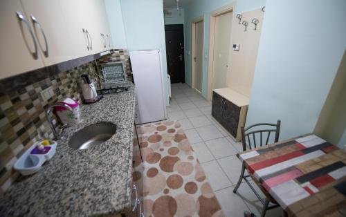 a kitchen with a sink and a refrigerator at Liman Apart Hotel in Isparta