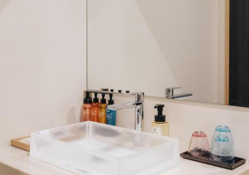 a white sink on a counter next to a mirror at Atami Fuga in Atami