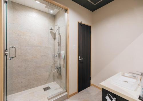 a bathroom with a shower and a sink at Atami Fuga in Atami