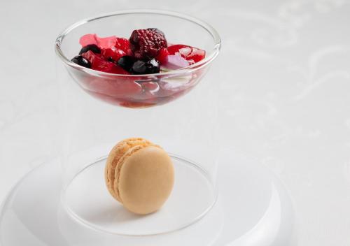 a glass bowl of fruit and a dessert on a plate at Atami Fuga in Atami