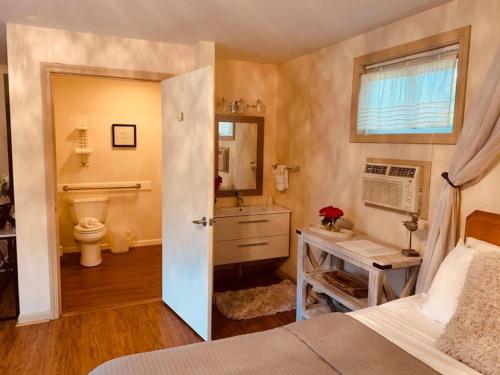 a bathroom with a bed and a sink and a toilet at Starlight Lodge at Rockport Harbor in Rockport