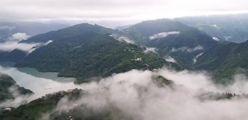 an aerial view of a mountain range with clouds at Victoria Peak Garden Suburb in Renai