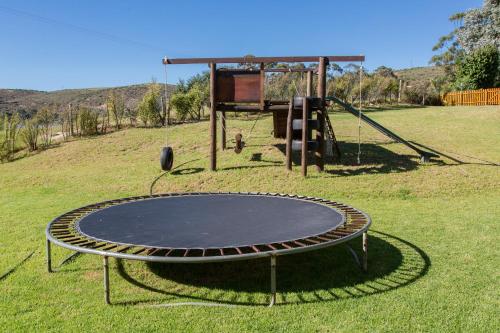 an empty trampoline in a field with a playground at Malagas Hotel in Malgas