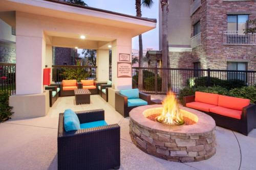 a courtyard with a fire pit and chairs and a building at Staybridge Suites Phoenix Glendale Sports Dist by IHG in Glendale