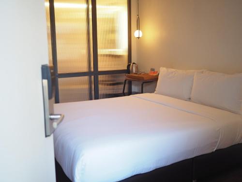 Ένα ή περισσότερα κρεβάτια σε δωμάτιο στο Wonderwall Hotel