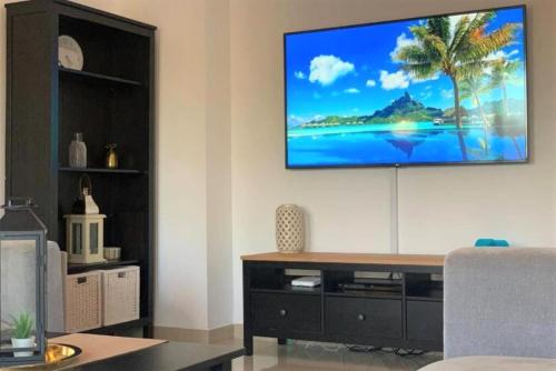 A television and/or entertainment center at Fairways luxury pool villa