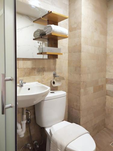 a bathroom with a toilet and a sink at Anex Hotel near US Embassy in Manila