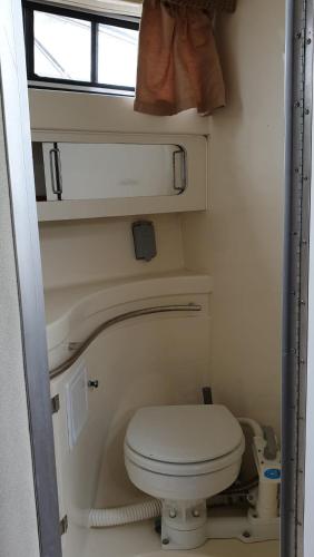 a small bathroom with a toilet and a window at MAGIC - MAGIC POINT in Mangalia
