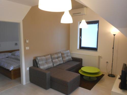 a living room with a couch and a bed at Apartment Knap in Cerknica