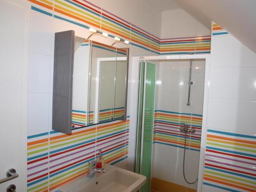 a bathroom with a rainbow shower and a sink at Apartment Knap in Cerknica