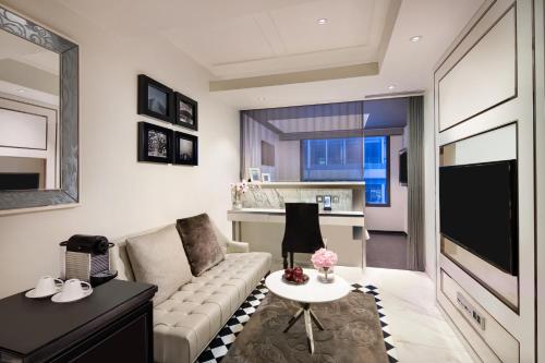 a living room with a couch and a table at Hotel Pravo Hong Kong in Hong Kong