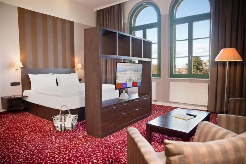 a hotel room with a bed and a living room at Schlosshotel Blankenburg in Blankenburg