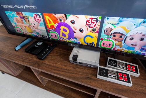 a flat screen tv sitting on a wooden table at Time To Relax v 3BR Geo Bukit Rimau,Shah Alam by Verano in Shah Alam