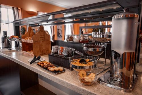 a kitchen with a counter with some food on it at River Palace Hotel in Atyraū