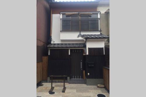 a view of the entrance to a building with black doors at Fushimi Inari House in Kyoto