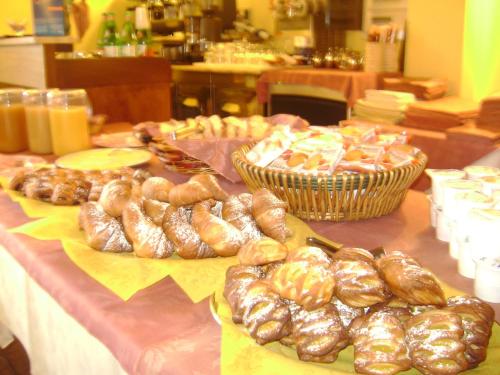 a table topped with lots of different types of pastries at Ai Vecchi Crateri in SantʼAlfio