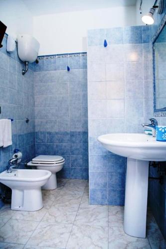 a bathroom with a sink and a toilet and a sink at Sant'Anna affittacamere in Alghero