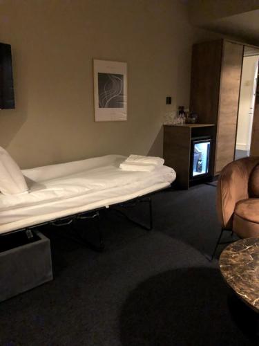 a room with a bed and a couch and a fireplace at Hotell Viktors in Sälen