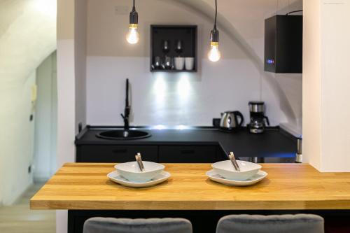 a kitchen with a wooden table with two bowls on it at Apartment Bolzano in Bolzano