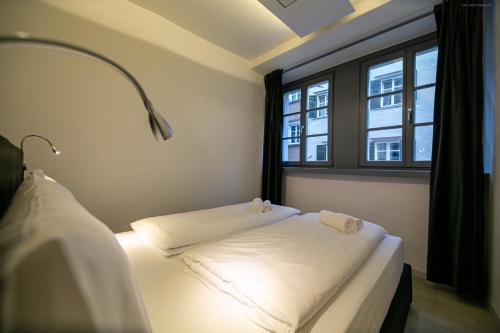 two beds in a room with a window at Apartment Bolzano in Bolzano
