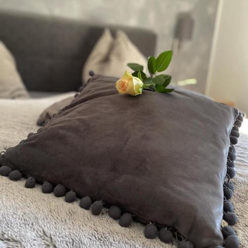 a pillow with a flower on top of it on a bed at Schusterhof Dölsach in Dölsach