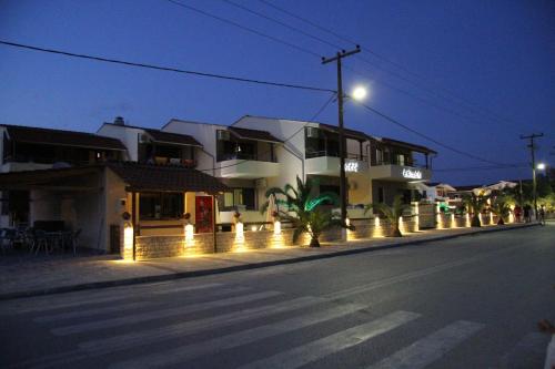 a street with a building with lights on the sidewalk at Aphrodite in Keramotí