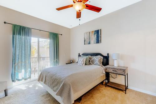 a bedroom with a bed and a ceiling fan at Magic St in Orlando