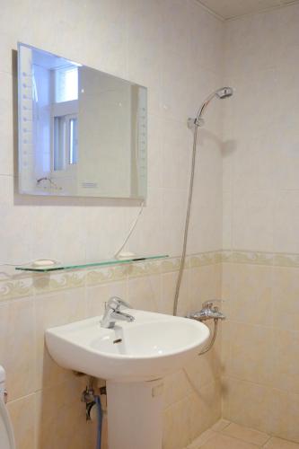a bathroom with a sink and a mirror and a shower at Skyview B&B in Ji'an