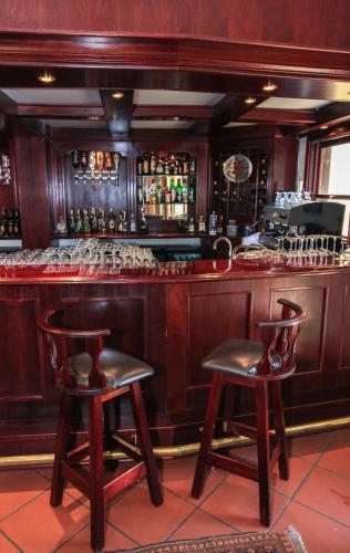 a bar with two chairs in front of a counter at Budmarsh Country Lodge in Magaliesburg