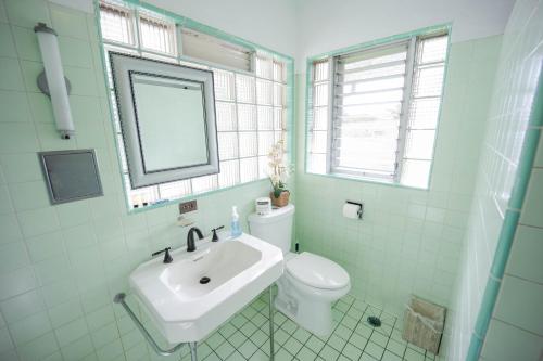 a bathroom with a sink, toilet and tub at Hilltop Legacy Vacation Rental in Hilo
