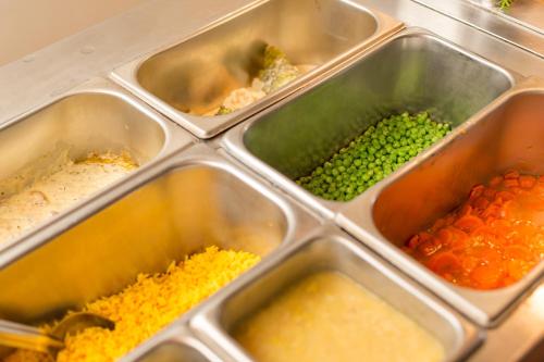 a metal container filled with different types of food at Malagas Hotel in Malgas