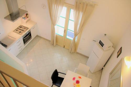 an overhead view of a kitchen with a table and a window at Villa Ginestra sulla spiaggia di Stromboli in Stromboli