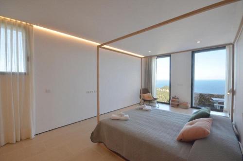 a bedroom with a large bed with a view of the ocean at VILLA BONITA - REF 216 in Begur