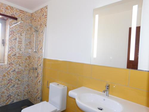 a bathroom with a sink and a toilet and a mirror at Casa Cho Silvestre in Tiscamanita