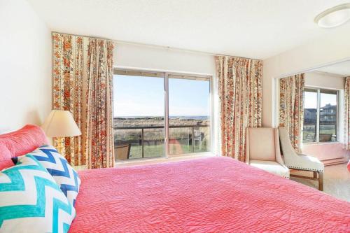 a bedroom with a bed and a large window at Heron Condo in Moclips