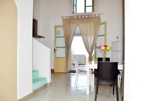 a dining room with a table and chairs at Villa Ginestra sulla spiaggia di Stromboli in Stromboli