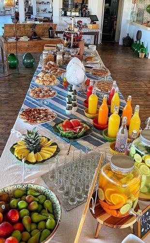 una mesa larga con muchos platos de comida y bebida en Borgo Rosso Terra, en Gallipoli