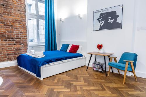 a bedroom with a bed and a table and a chair at 2BCOMFY - Nad Niprem in Bielsko-Biała