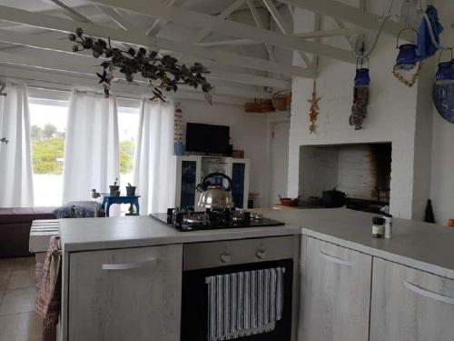 a kitchen with a stove and a counter top at SONVANGER VILLA YZERFONTEIN in Yzerfontein