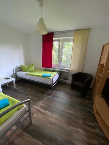 a living room with a bed and a window at Ruhige 3-Zimmerwohnung im Norden Bremens für Monteure und Geschäftsreisende in Bremen