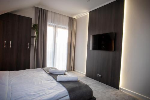 a bedroom with a bed with two towels on it at Villa Warchały in Narty