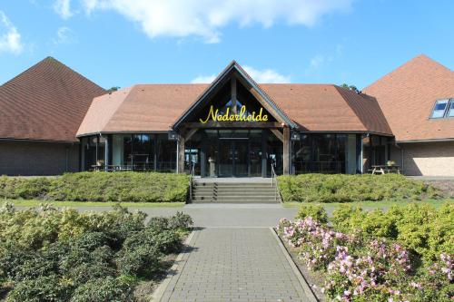 a building with a sign on the front of it at Hotel restaurant Nederheide in Milheeze