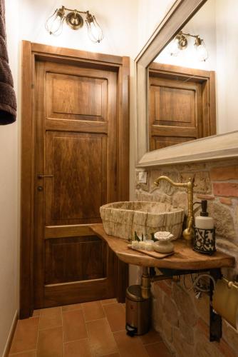 a bathroom with a stone sink and a mirror at Hortus Conclusus + free parking in Siena