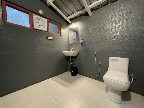 a bathroom with a toilet and a sink at Commune18 Resort Chikmagalur in Chikmagalūr