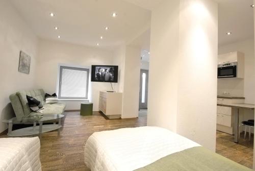 a bedroom with two beds and a living room at Appartement Haberl in Bruck an der Mur