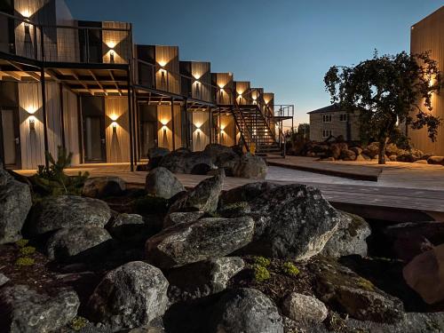 a building with rocks in front of it at night at Гостевой комплекс Dubki in Dubki