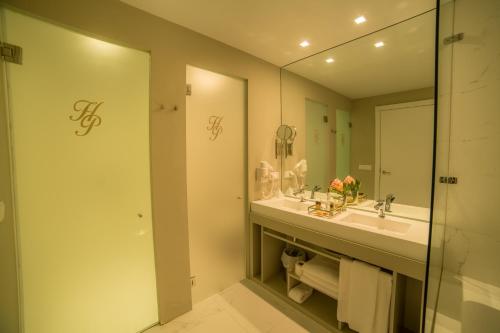 a bathroom with a sink and a mirror at Hotel do Parque in Braga