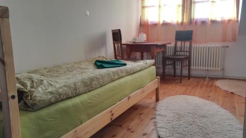 a bedroom with a bed and a table and chairs at Farma Hermína in Jilemnice