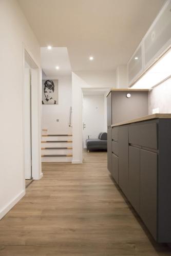 a kitchen with white walls and a wooden floor at Main Motel in Dorfprozelten