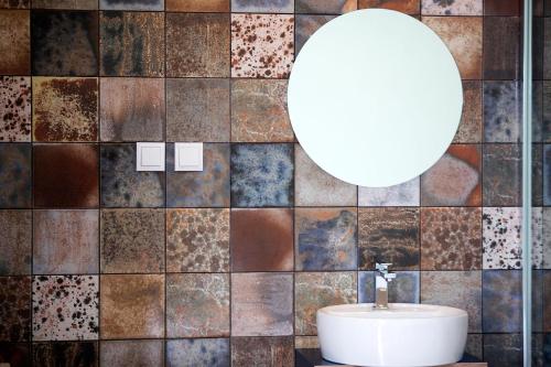 a bathroom with a sink and a mirror at Salt Lips Surf & Coworking Azores in Ponta Delgada